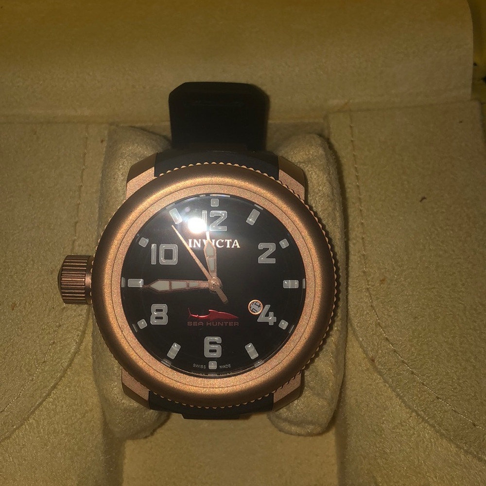 Invicta gold men’s strap watch.